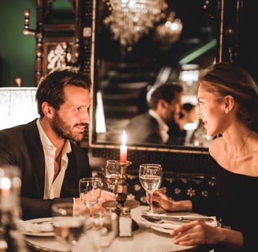 a sugar bay and sugar mommy sitting at a table with candles