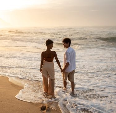 a couple holding hands on a beach