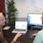 A woman mentoring a younger man in a professional setting.