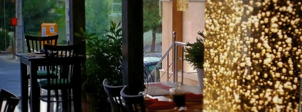 a restaurant with a large window and a table with chairs