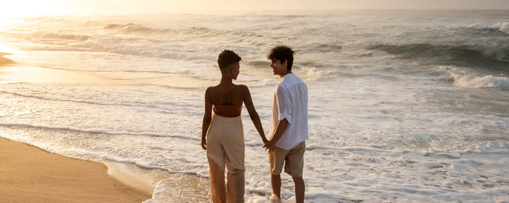 a couple holding hands on a beach