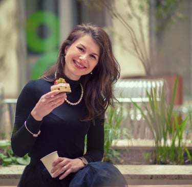 a sugar mommy sitting on a bench with a pastry