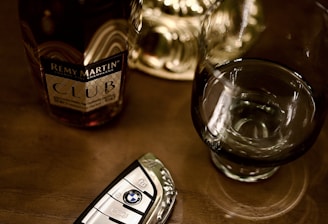 Bottle of remy martin, car key, and glass