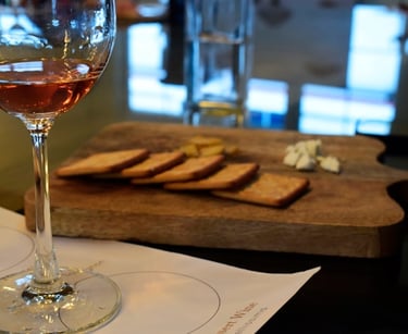 a glass of wine and bread on a table